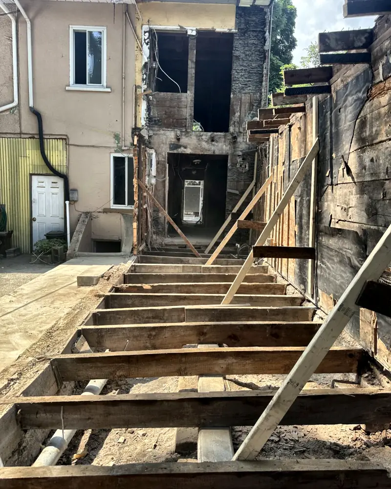 Outdoor stairs and balcony being demolished